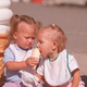 Toddlers sharing ice cream cone